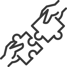 Two hands holding puzzle pieces fitting together.